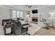 Comfortable living room showcasing a stone fireplace, TV, and a cozy seating area with natural light at 4000 Rockingham Dr, Roswell, GA 30075