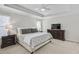 Serene primary bedroom featuring a tray ceiling, soft carpet, and generous space, designed for ultimate comfort at 4000 Rockingham Dr, Roswell, GA 30075