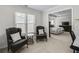 View of sitting area with two chairs looking into a bedroom with a large bed and entertainment center at 4000 Rockingham Dr, Roswell, GA 30075