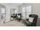 Cozy sitting room filled with natural light, features comfortable armchairs and stylish decor, ideal for relaxation at 4000 Rockingham Dr, Roswell, GA 30075