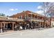 Two-story building with a commercial street front, outdoor seating, and unique architectural charm at 4000 Rockingham Dr, Roswell, GA 30075