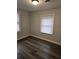 Bedroom with wood-look flooring and a double window for great natural light at 5709 Lee St, Morrow, GA 30260