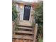 View of the entrance to the home with steps leading up to the front door at 5709 Lee St, Morrow, GA 30260