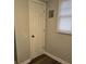 Hallway with a utility door, bright natural light, and modern flooring at 5709 Lee St, Morrow, GA 30260