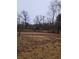 View of a partially cleared lot with objects in background at 5709 Lee St, Morrow, GA 30260