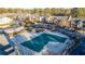 Aerial view of the community pool with a green safety cover and surrounding residential buildings at 6851 Roswell Rd # F32, Sandy Springs, GA 30328