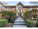 Well-maintained building entrance with manicured bushes, a concrete walkway, and a secure entry door at 6851 Roswell Rd # F32, Sandy Springs, GA 30328