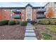 Beautiful exterior of condo building featuring lush landscaping and attractive brick facade at 6851 Roswell Rd # F32, Sandy Springs, GA 30328