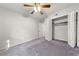 Bedroom with carpet, a closet, ceiling fan and a door leading to another room at 6851 Roswell Rd # F32, Sandy Springs, GA 30328