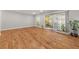 Open living area featuring hardwood floors, neutral walls, and large windows at 6851 Roswell Rd # F32, Sandy Springs, GA 30328