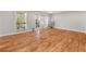 Bright living room featuring shiny hardwood floors, large windows, and access to the patio at 6851 Roswell Rd # F32, Sandy Springs, GA 30328