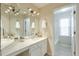 Bathroom showcasing dual sinks, large mirror, and access to bathtub/shower at 893 Lance Cir, Lawrenceville, GA 30043