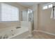 Modern bathroom with a soaking tub, glass-enclosed shower, and natural light at 893 Lance Cir, Lawrenceville, GA 30043