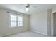 Bedroom featuring a window, ceiling fan, and neutral paint throughout at 893 Lance Cir, Lawrenceville, GA 30043