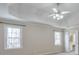 Bright bedroom features a tray ceiling, ceiling fan, and two large windows at 893 Lance Cir, Lawrenceville, GA 30043