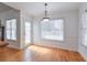 Bright dining area with hardwood floors, white walls, and an elegant pendant light at 893 Lance Cir, Lawrenceville, GA 30043