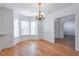 Light-filled dining room with hardwood floors, white walls, and a chandelier at 893 Lance Cir, Lawrenceville, GA 30043