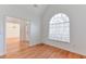 Bright, empty room with hardwood floors, white walls, and a large window at 893 Lance Cir, Lawrenceville, GA 30043