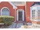 Close-up of the home's front door with brick accents and decorative windows on the left side at 893 Lance Cir, Lawrenceville, GA 30043