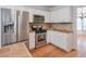 Stylish kitchen with stainless steel appliances, white cabinetry, and hardwood floors at 893 Lance Cir, Lawrenceville, GA 30043