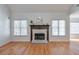 Cozy living room with a fireplace, hardwood floors, and natural lighting at 893 Lance Cir, Lawrenceville, GA 30043