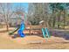 A spacious backyard includes a large wooden playset with multiple slides, climbing features, and a swing for outdoor fun at 893 Lance Cir, Lawrenceville, GA 30043