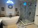 Beautiful bathroom featuring a standalone tub, glass shower, and a large arched window at 108 Ardsley Run, Canton, GA 30115