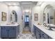 Dual sink bathroom featuring blue cabinets, marble countertops, and a decorative tile floor at 108 Ardsley Run, Canton, GA 30115