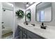 Bright bathroom featuring a double sink vanity, stylish mirrors, and a shower-tub combo at 108 Ardsley Run, Canton, GA 30115