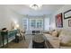 Relaxing sitting room with carpet, white sofa, a bookshelf, and natural light at 108 Ardsley Run, Canton, GA 30115