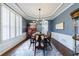 Traditional dining room with wainscoting, tray ceiling, and a view of the bright windows at 108 Ardsley Run, Canton, GA 30115