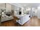 Kitchen with an island, marble countertop, stainless steel appliances, hardwood floors, and a view of the living room at 108 Ardsley Run, Canton, GA 30115