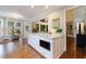 Kitchen island with marble countertop, seating, and built-in microwave in a sunlit, open floor plan at 108 Ardsley Run, Canton, GA 30115