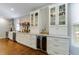 Well-lit kitchen features stainless steel appliances, white cabinets, hardwood floors, and plenty of counter space at 108 Ardsley Run, Canton, GA 30115