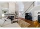 Inviting living room with a fireplace, built-in bookshelves, wood floors, and a staircase at 108 Ardsley Run, Canton, GA 30115