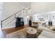 Spacious living room featuring high ceilings, hardwood floors, and an open connection to the kitchen at 108 Ardsley Run, Canton, GA 30115