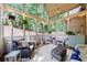 Cozy sunroom with wicker furniture, string lights, and views of the backyard at 108 Ardsley Run, Canton, GA 30115