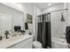 Stylish bathroom features a tub with a shower, a sleek vanity, and decorative accents at 1322 Stanley Park Dr, Decatur, GA 30033