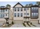 Modern townhome exterior with attached garages and neutral color palette at 1322 Stanley Park Dr, Decatur, GA 30033