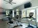 Bright gym featuring updated equipment, ceiling fans, a wall-mounted television and large windows at 1322 Stanley Park Dr, Decatur, GA 30033