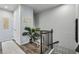 Bright hallway featuring a staircase with dark wood railing, and neutral decor at 1322 Stanley Park Dr, Decatur, GA 30033