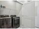 This laundry room features modern black appliances and wire shelving for storage at 1322 Stanley Park Dr, Decatur, GA 30033