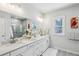 Elegant main bathroom features double sinks with white cabinetry, granite countertop, large mirror, and a glass-enclosed shower at 1322 Stanley Park Dr, Decatur, GA 30033