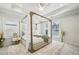 Spacious main bedroom with a decorative four-poster bed and tray ceiling at 1322 Stanley Park Dr, Decatur, GA 30033