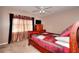 Bedroom featuring a decorative bed frame, ceiling fan, and large window with curtains at 3064 Zermatt Way, Snellville, GA 30078