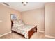 Bedroom with a decorative bed frame, neutral carpeting, and blank walls at 3064 Zermatt Way, Snellville, GA 30078