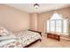 Bedroom featuring a window with blinds and curtains, a chest, and carpeting at 3064 Zermatt Way, Snellville, GA 30078