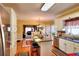 Well-lit kitchen with a central island, granite countertops, and hardwood floors, seamlessly connected to the dining area at 3064 Zermatt Way, Snellville, GA 30078