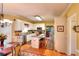 Cozy kitchen with white cabinetry, a central island, and hardwood floors, complemented by natural light at 3064 Zermatt Way, Snellville, GA 30078