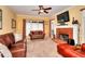 Cozy living room with a ceiling fan, fireplace and plush furniture at 3064 Zermatt Way, Snellville, GA 30078